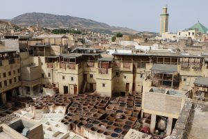 In the heart of the winding, twisting Fez medina sit leather tanneries with one of dozens of minarets in the background.